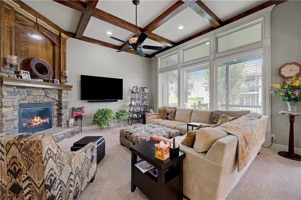 Tall ceilings, fireplace and statement lighting at 4323 NE Park Trails Court, Lee's Summit, MO 64064