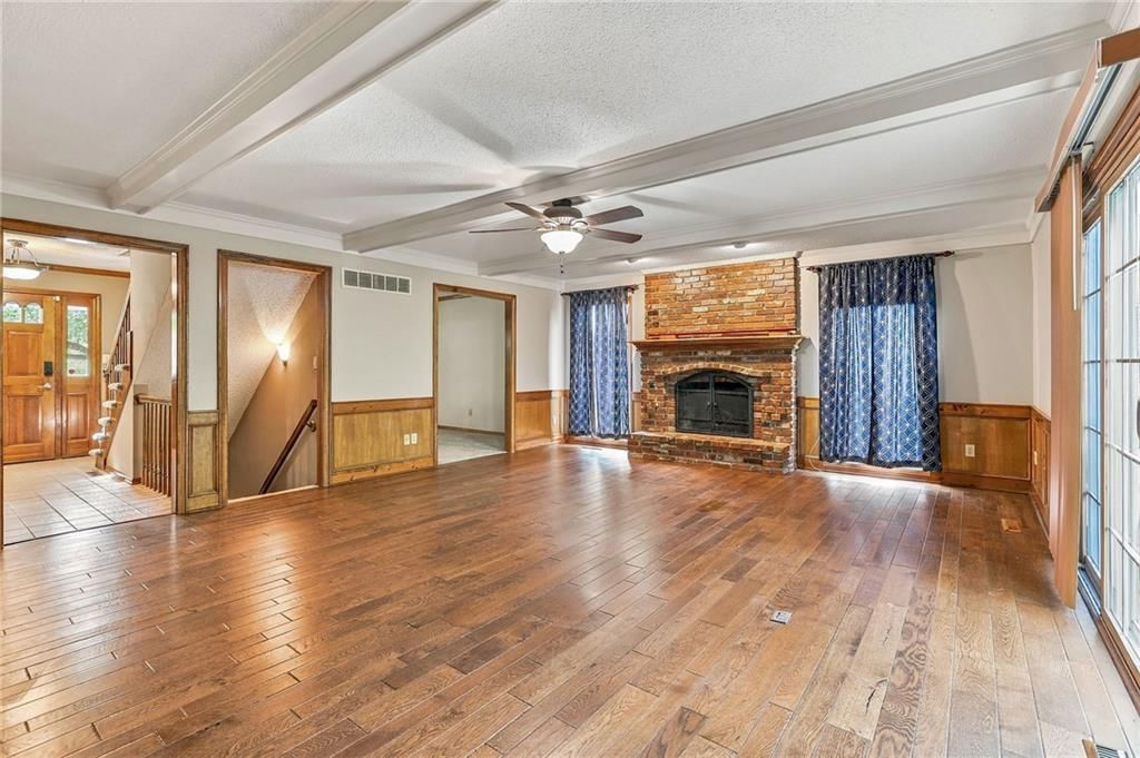 Fireplace, open floor plan and hardwood floors at 17612 E 48th Terrace Court S, Independence, MO 64055