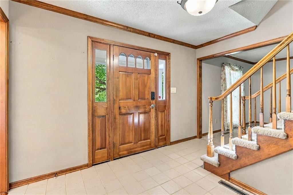Staircase, wood stair railing and white trim at 17612 E 48th Terrace Court S, Independence, MO 64055