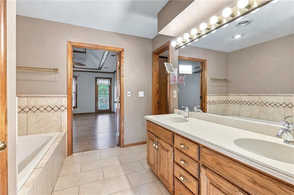 Tile floors, tiled shower and tub and shower combo at 17612 E 48th Terrace Court S, Independence, MO 64055