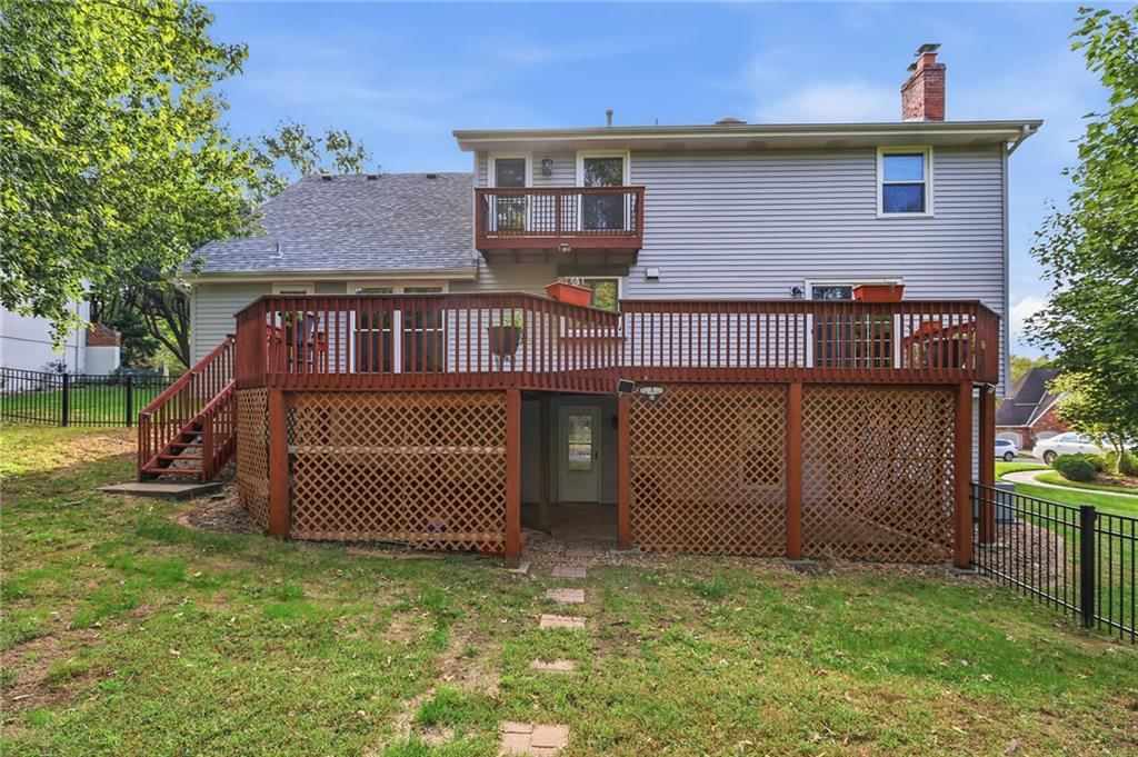 Fenced yard, iron fence and wood deck at 17612 E 48th Terrace Court S, Independence, MO 64055