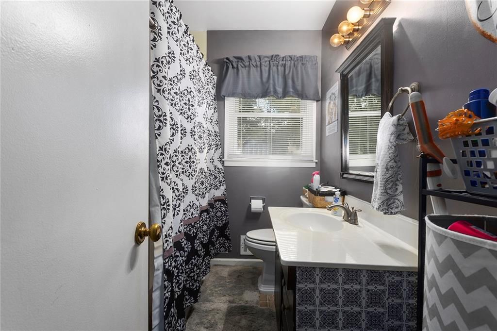 Tiled shower and double vanity at 2 NE 62 Terrace, Gladstone, MO 64118