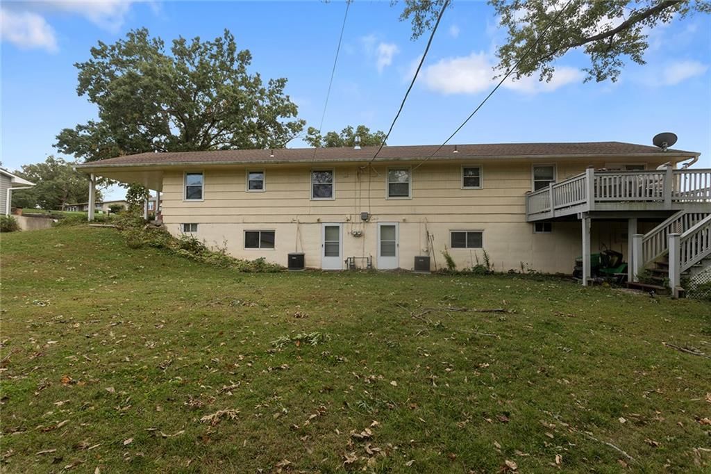 Asphalt shingle roof and beige exterior at 2 NE 62 Terrace, Gladstone, MO 64118