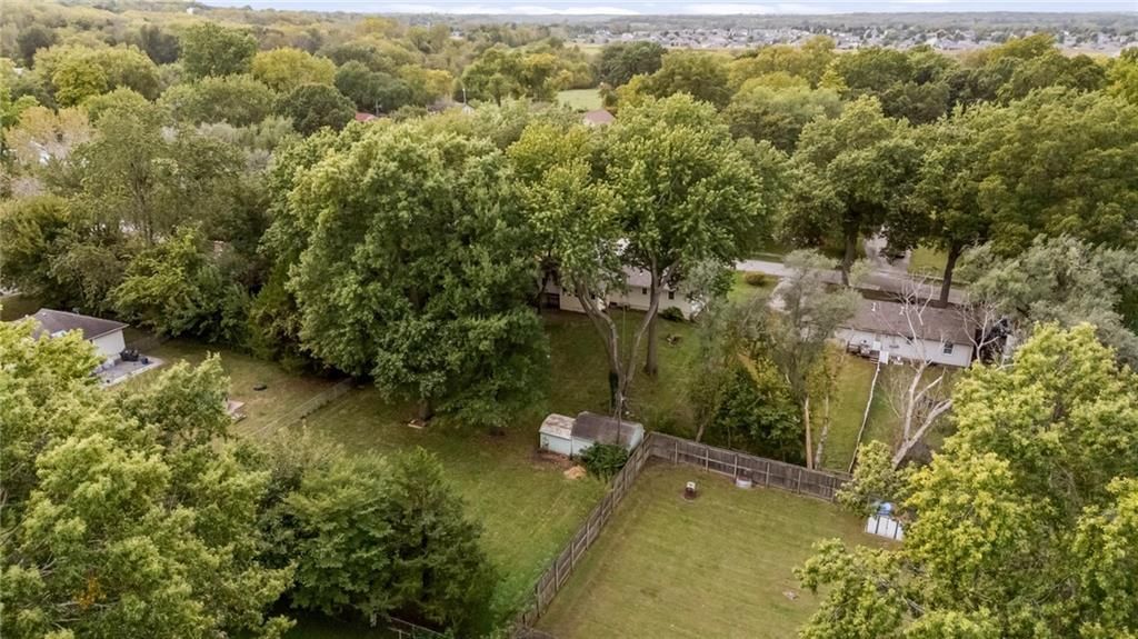 Pond or creek visible on the lot at 705 SW Mitchell Street, Oak Grove, MO 64075
