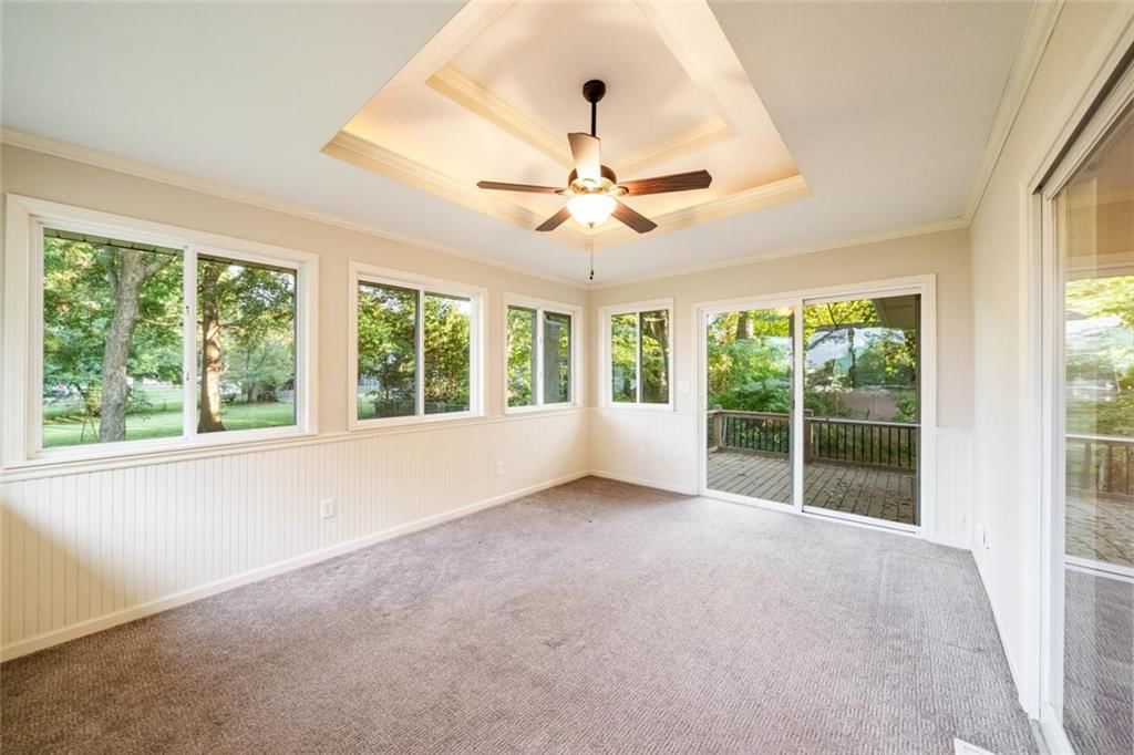 Open floor plan, tray ceiling and wall of windows at 705 SW Mitchell Street, Oak Grove, MO 64075