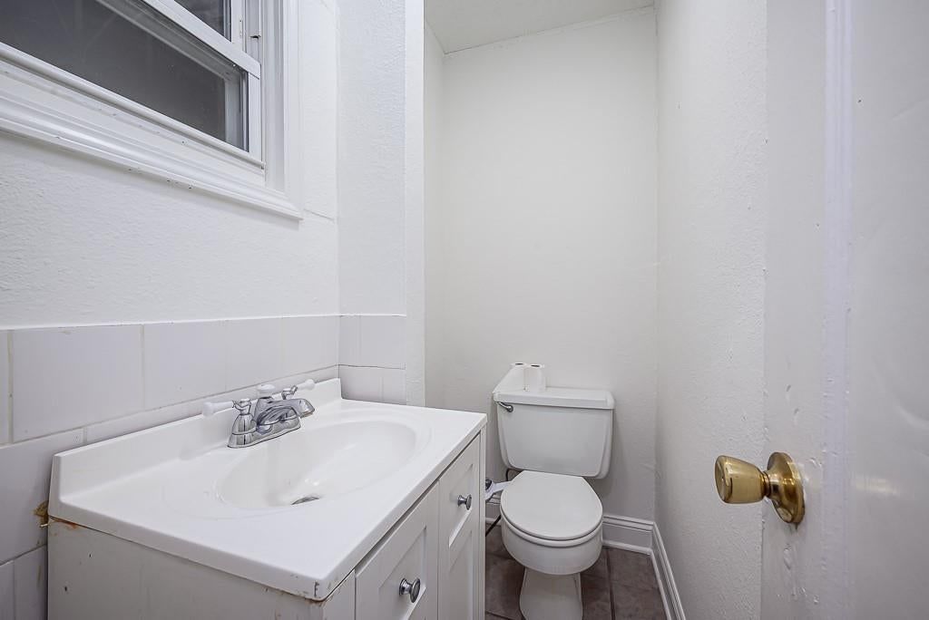 Wainscoting or board and batten and white vanity at 5828 Paseo Boulevard, Kansas City, MO 64110
