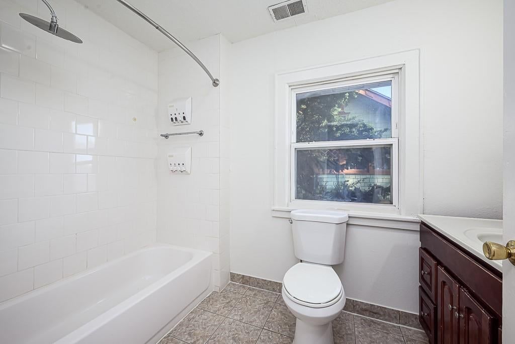 Tiled shower and tub and shower combo at 5828 Paseo Boulevard, Kansas City, MO 64110