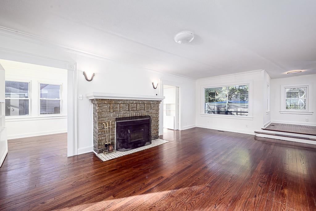 Fireplace, hardwood floors and brick fireplace at 5828 Paseo Boulevard, Kansas City, MO 64110