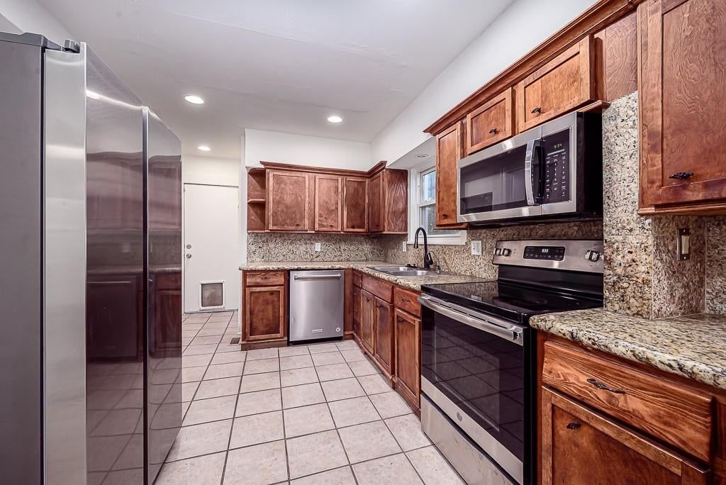 Granite counters, tile floors and stainless steel appliances at 5828 Paseo Boulevard, Kansas City, MO 64110