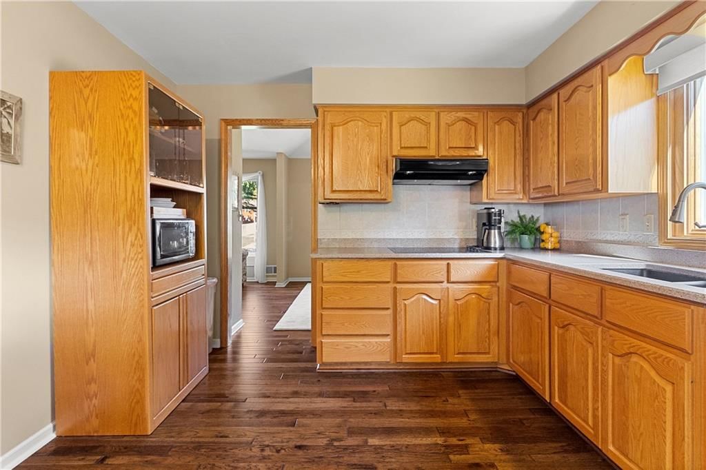 Wood kitchen cabinets, black appliances and raised-panel cabinets at 10909 W 102nd Street, Overland Park, KS 66214