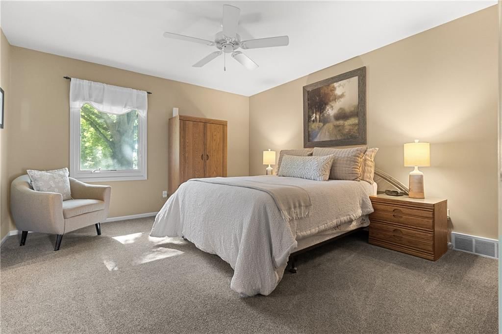 Main-floor primary bedroom, bedroom sitting area and carpet at 10909 W 102nd Street, Overland Park, KS 66214