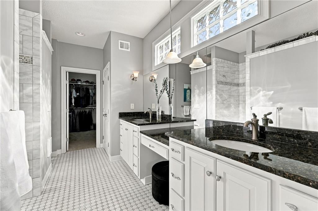 Walk-in shower, double vanity and frameless glass shower at 7810 NW Scenic Drive, Weatherby Lake, MO 64152