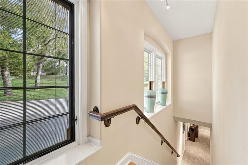 Black window frames and staircase at 7810 NW Scenic Drive, Weatherby Lake, MO 64152