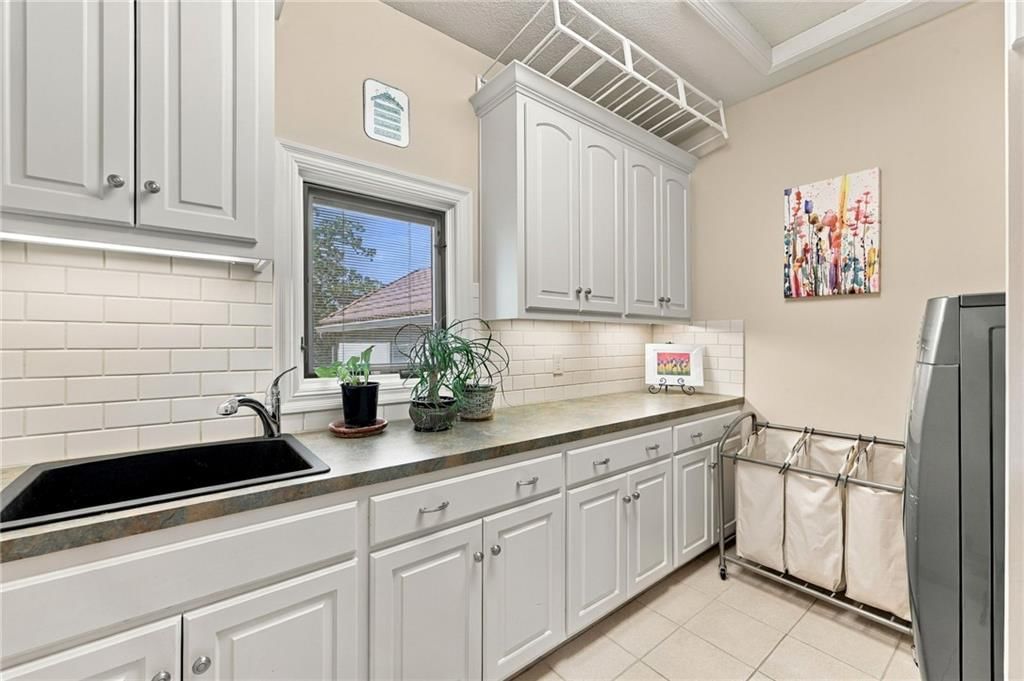 White kitchen and tile floors at 7810 NW Scenic Drive, Weatherby Lake, MO 64152