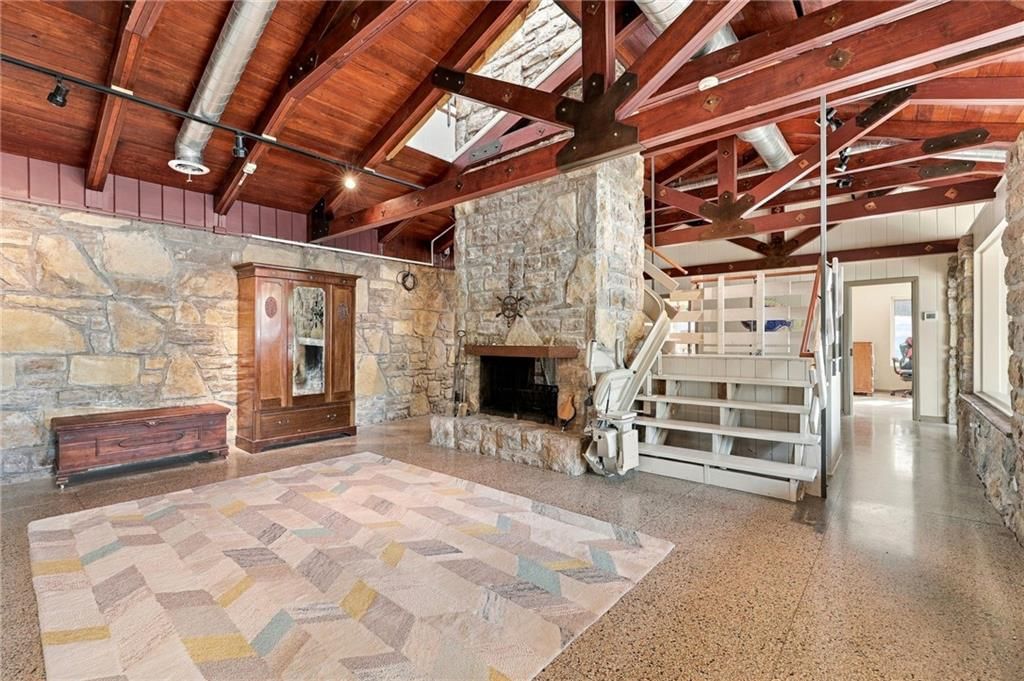 Open-riser staircase and wood stair railing at 7810 NW Scenic Drive, Weatherby Lake, MO 64152