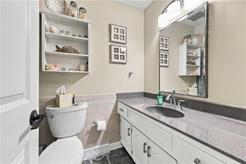 Tiled shower, double vanity and white vanity at 12908 E 58th Street, Kansas City, MO 64133