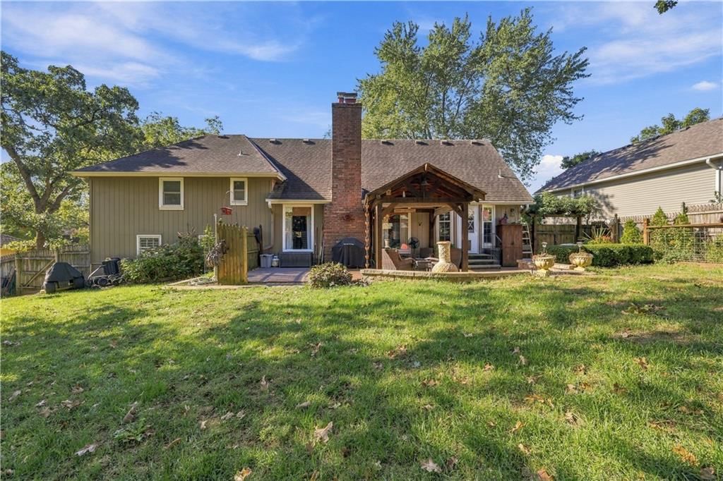 Covered front porch, big backyard and mature trees at 12908 E 58th Street, Kansas City, MO 64133