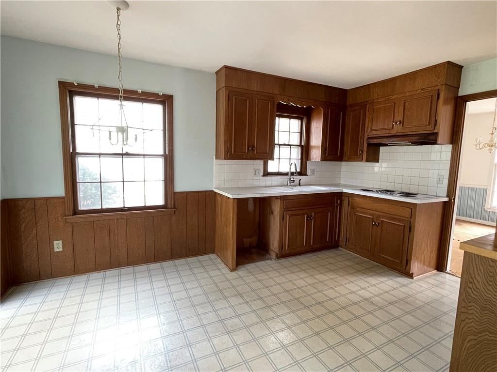Wood kitchen cabinets, electric range and kitchen backsplash at 6926 W 101st Street, Overland Park, KS 66212