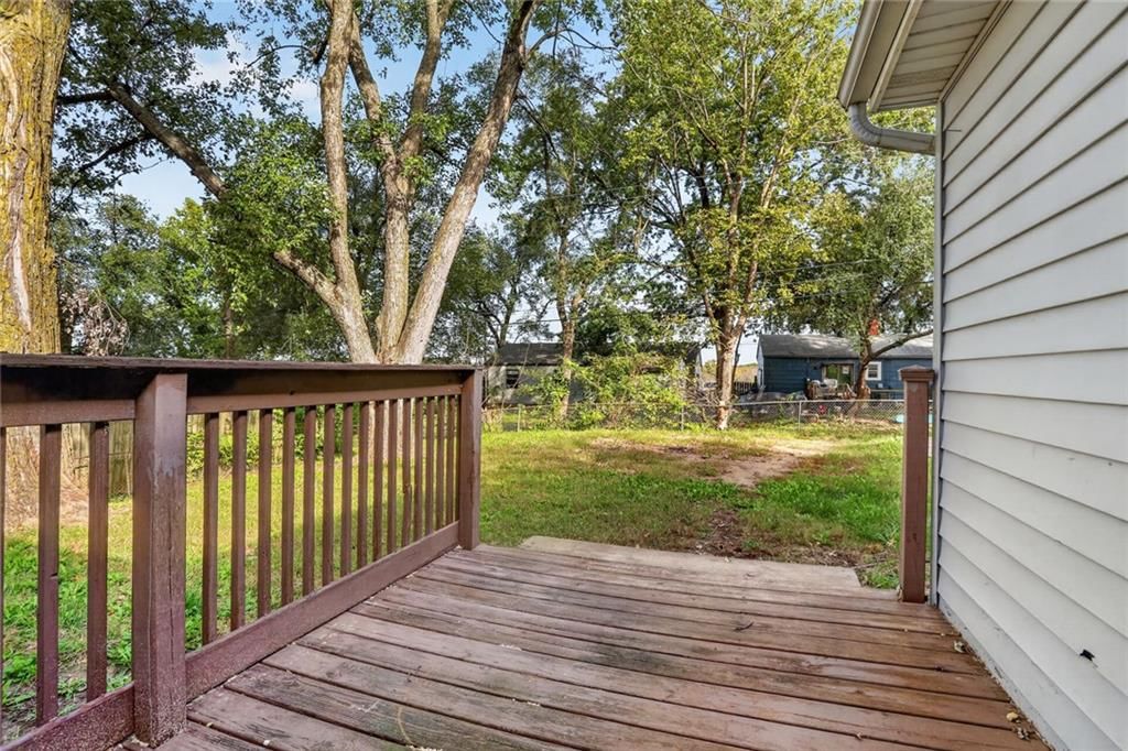 Deck, big backyard and mature trees at 6202 E 147th Terrace, Grandview, MO 64030