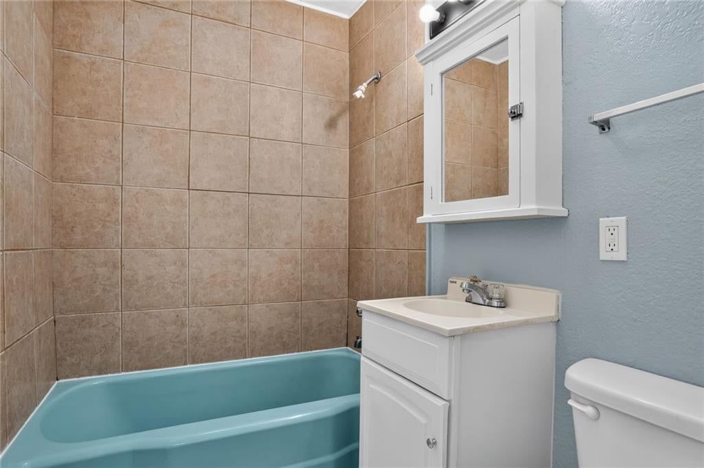 Tiled shower and tub and shower combo at 6202 E 147th Terrace, Grandview, MO 64030