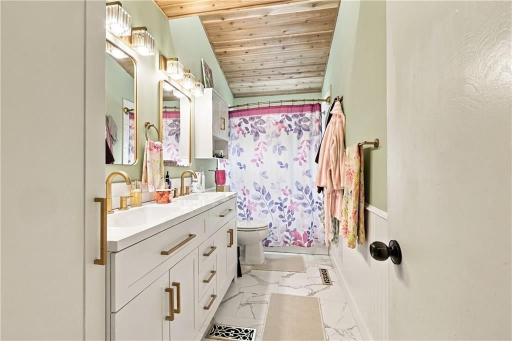 Double vanity and black hardware at 8427 Jame A Reed Road, Raytown, MO 64138