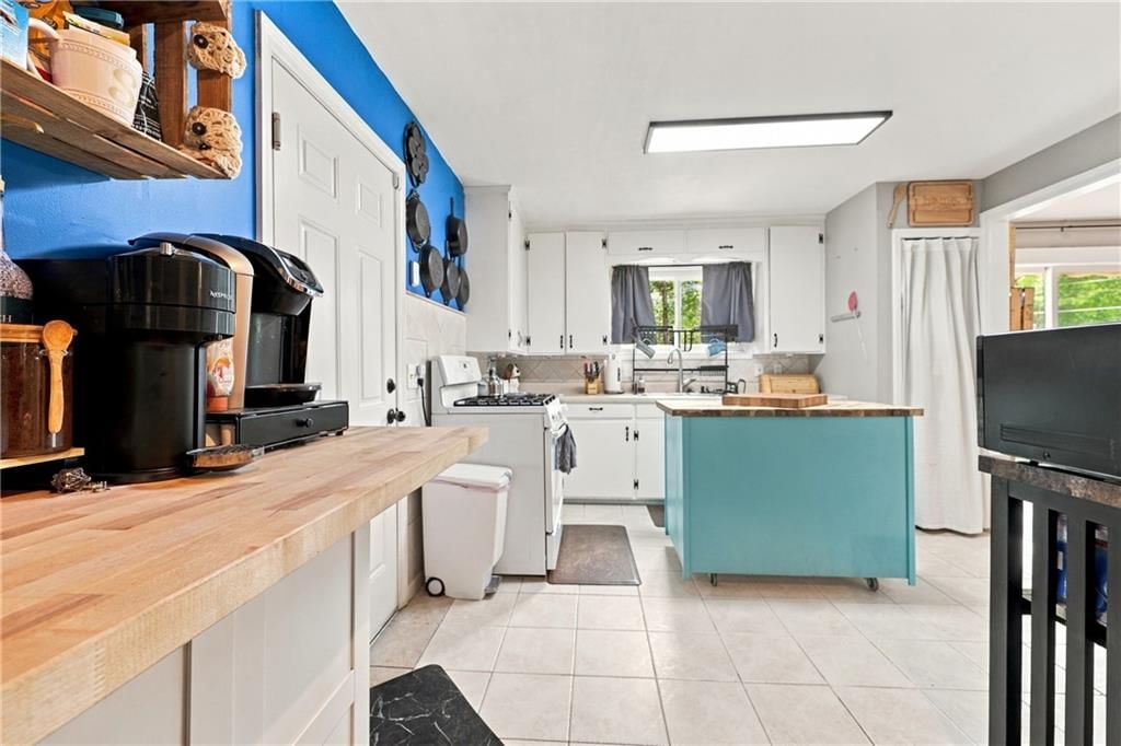 Photo 7: white kitchen cabinets, 8427 Jame A Reed Road, Raytown, MO 64138