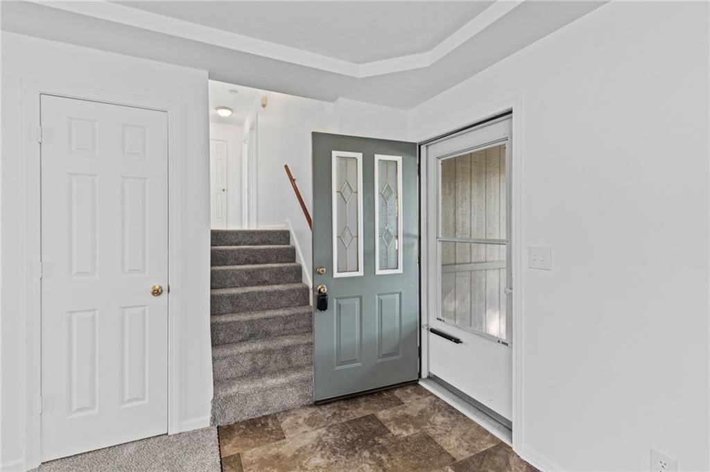 Tray ceiling, staircase and wood stair railing at 29408 Vickie Drive, Excelsior Springs, MO 64024