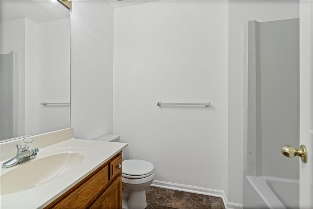 Tiled shower, wood vanity and renovated bathrooms at 29408 Vickie Drive, Excelsior Springs, MO 64024