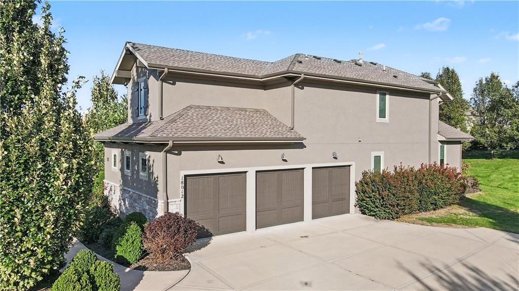Garage for three or more cars, attached garage and concrete driveway at 10812 W 153rd Street, Overland Park, KS 66221