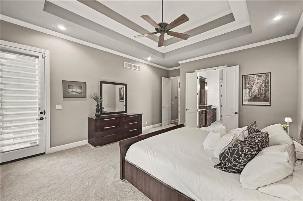 Main-floor primary bedroom, tray ceiling and carpet at 10812 W 153rd Street, Overland Park, KS 66221