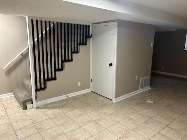 Finished basement, tile floors and staircase at 909/911 Madison Street, Leavenworth, KS 66048