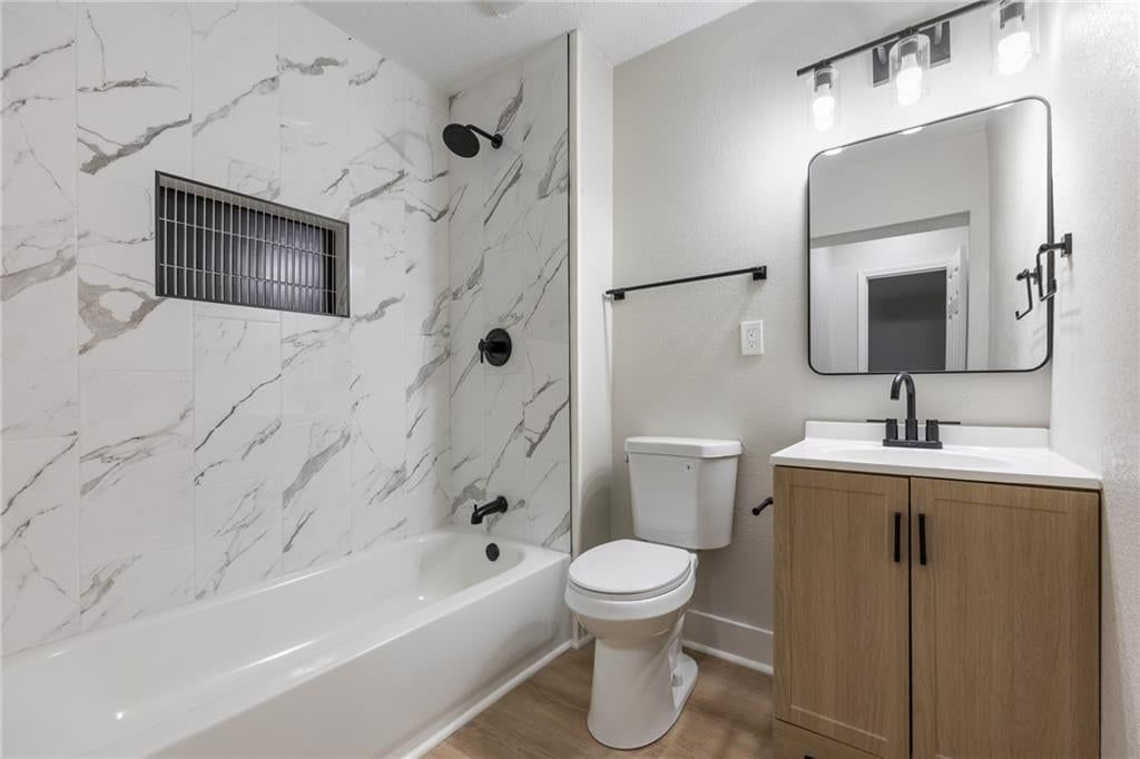 Tiled shower and renovated bathrooms at 3426 Cypress Avenue, Kansas City, MO 64130
