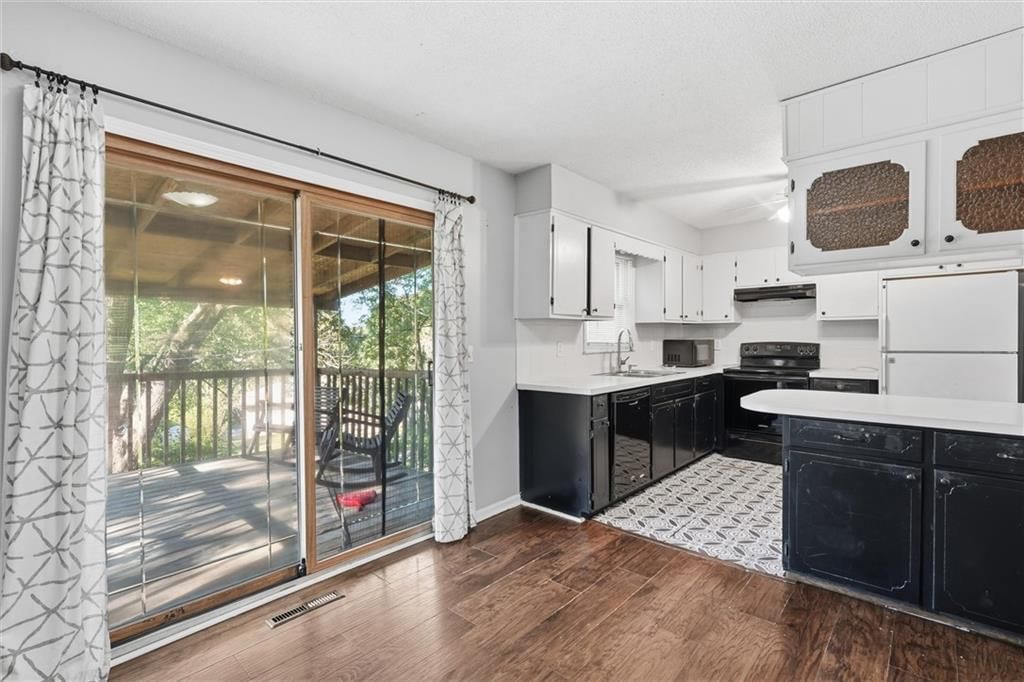 Kitchen island, quartz counters and two-tone kitchen cabinets at 2206 Wilson Avenue, Leavenworth, KS 66048