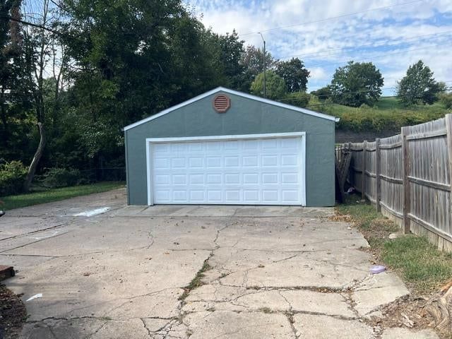 Fenced yard, concrete driveway and wood fence at 7432 Bellefontaine Avenue, Kansas City, MO 64132