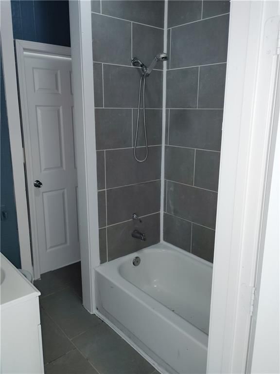 Tile floors and tiled shower at 3421 Flora Avenue, Kansas City, MO 64109