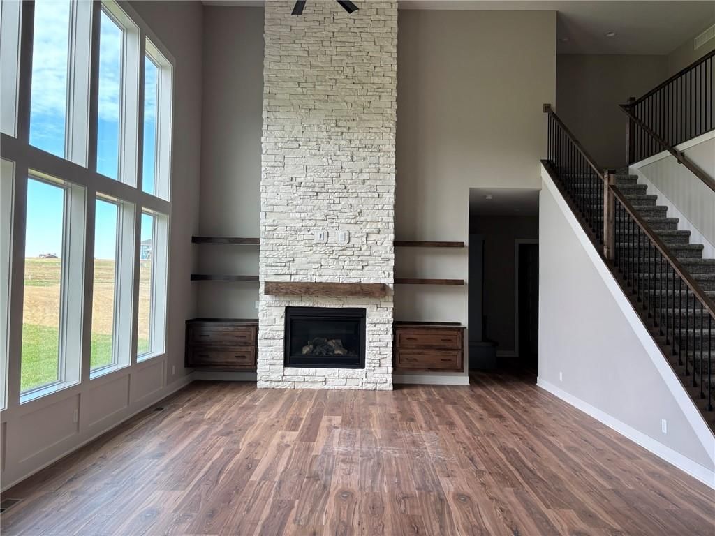 Fireplace, open floor plan and floor-to-ceiling windows at 1816 SW Arbormist Drive, Lee's Summit, MO 64082