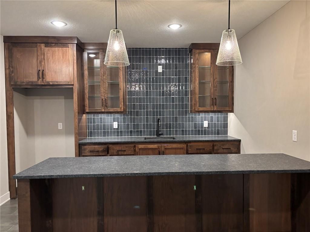 Statement lighting and wet bar at 1816 SW Arbormist Drive, Lee's Summit, MO 64082