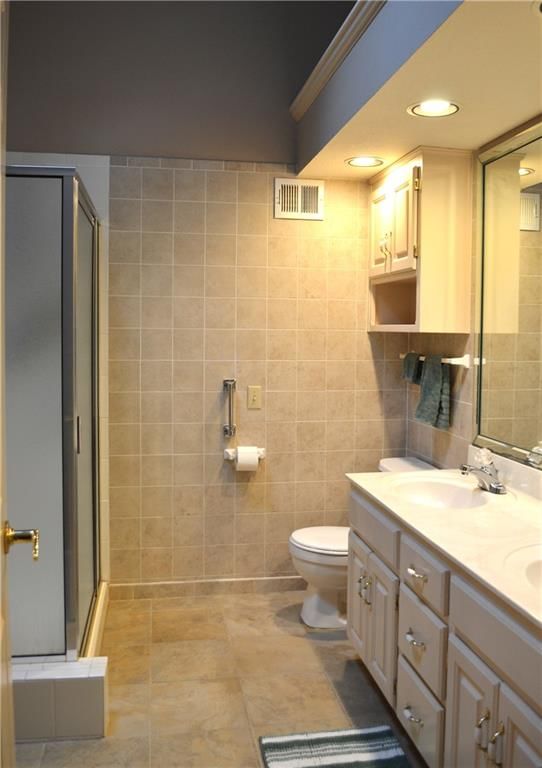Walk-in shower, tiled shower and double vanity at 3101 NE 63 Terrace, Gladstone, MO 64119