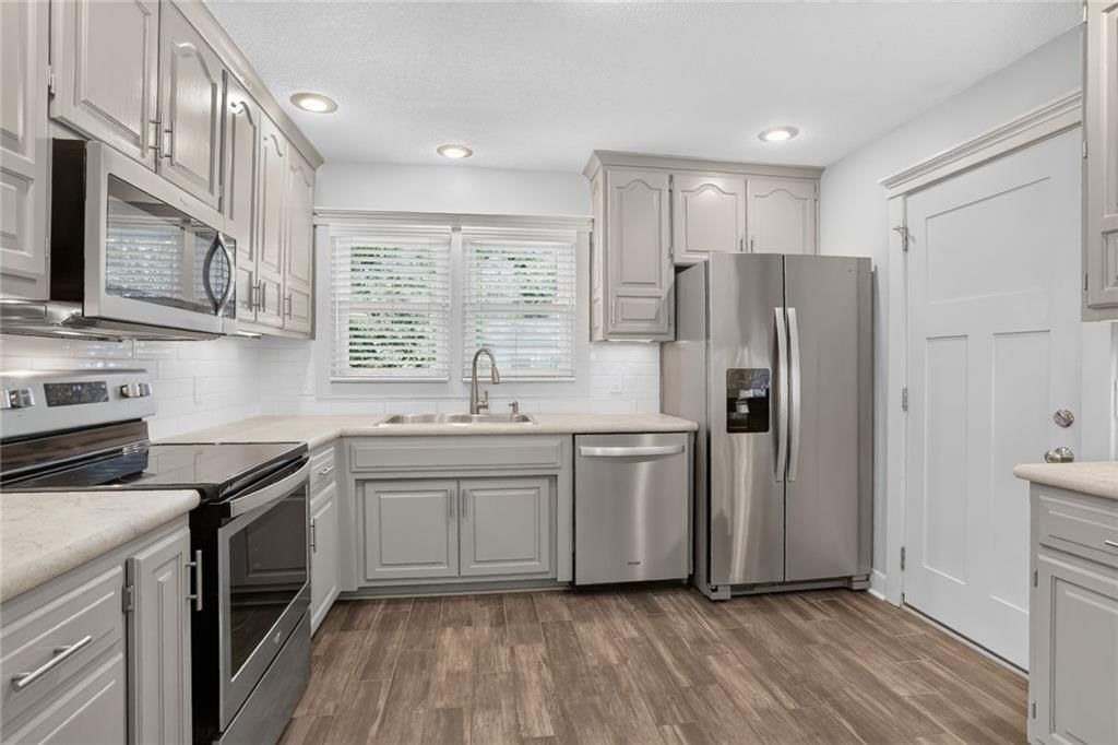 Gray kitchen cabinets, stainless steel appliances and updated kitchen at 5404 NE 43rd Street, Kansas City, MO 64117