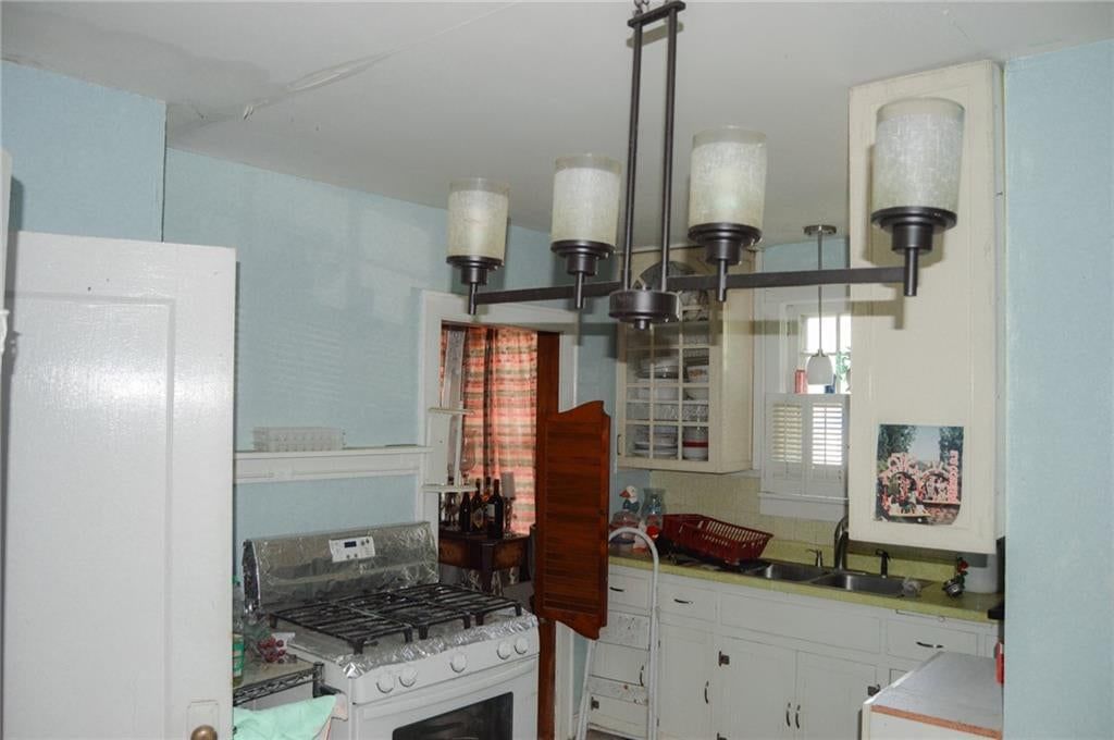 Kitchen open to the living area and white kitchen cabinets at 2503 Grandview Boulevard, Kansas City, KS 66102