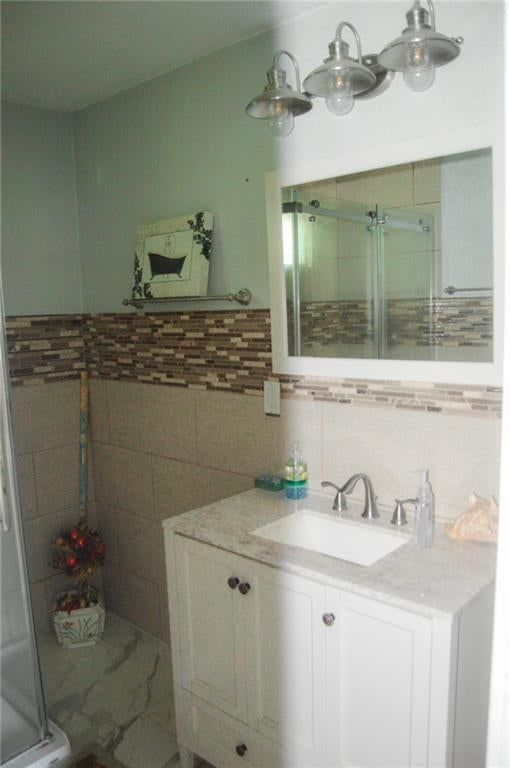 Tiled shower, white vanity and renovated bathrooms at 2503 Grandview Boulevard, Kansas City, KS 66102
