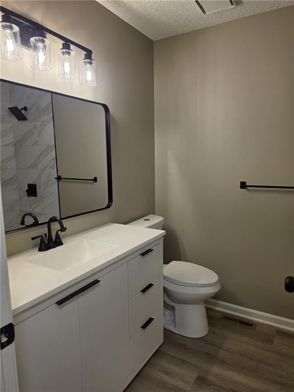 Tiled shower, frameless glass shower and white vanity at 603 SE 21st Street, Oak Grove, MO 64075