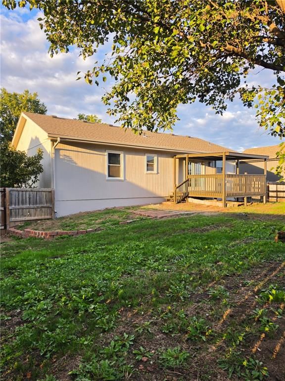 Deck, fenced yard and covered patio at 603 SE 21st Street, Oak Grove, MO 64075
