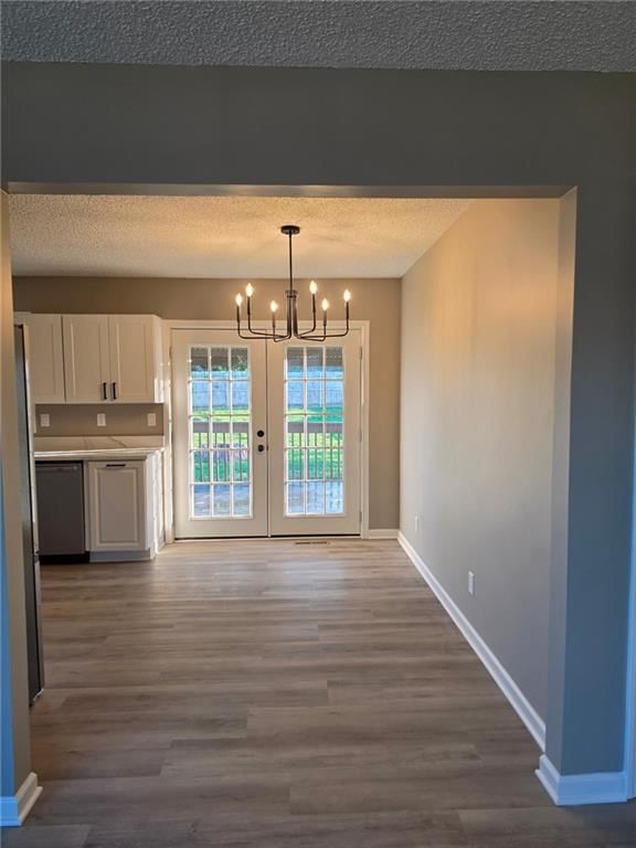 Open floor plan and statement lighting at 603 SE 21st Street, Oak Grove, MO 64075