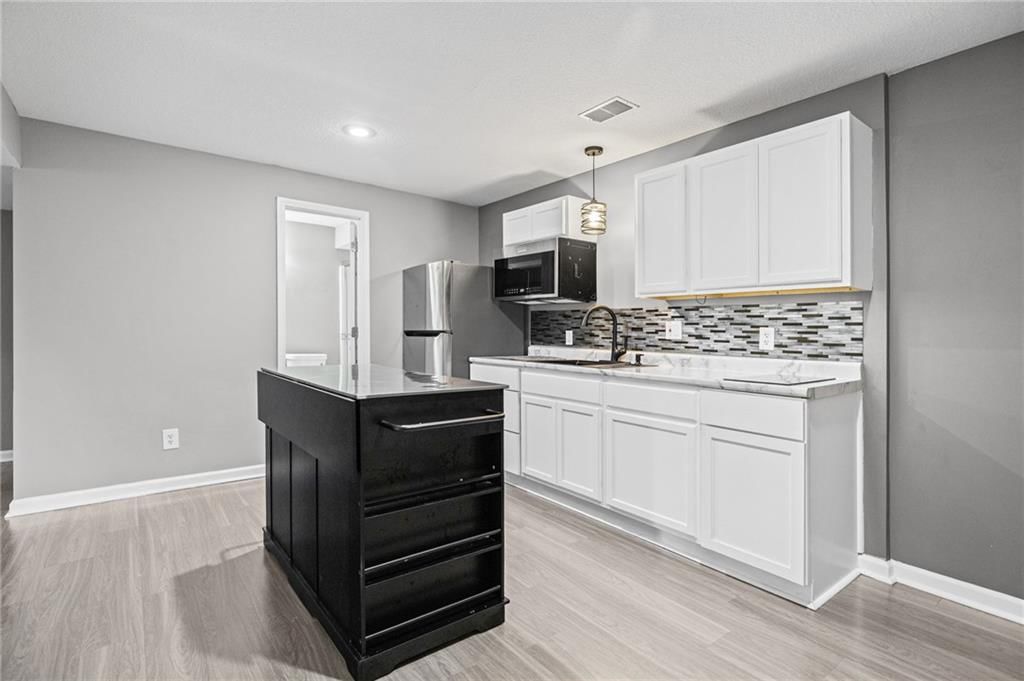 White kitchen and updated kitchen at 1703 NE 181st Terrace, Smithville, MO 64089