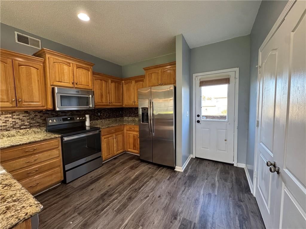 Granite counters, wood kitchen cabinets and updated kitchen at 2104 Garfield Avenue, Kansas City, MO 64127