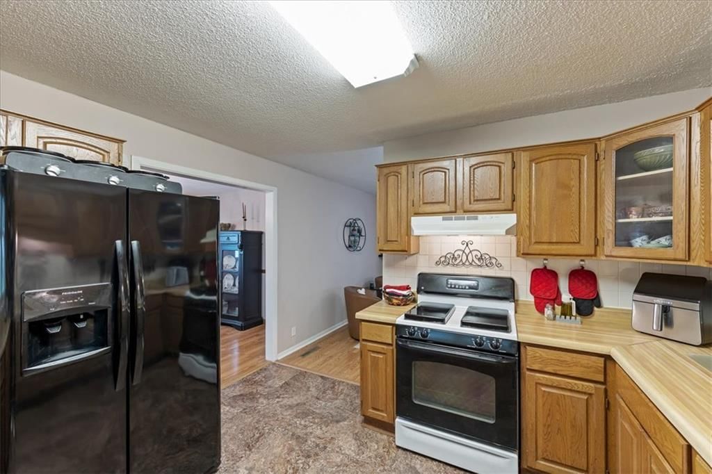 Double oven, black appliances and raised-panel cabinets at 503 NE 67th Terrace, Gladstone, MO 64118