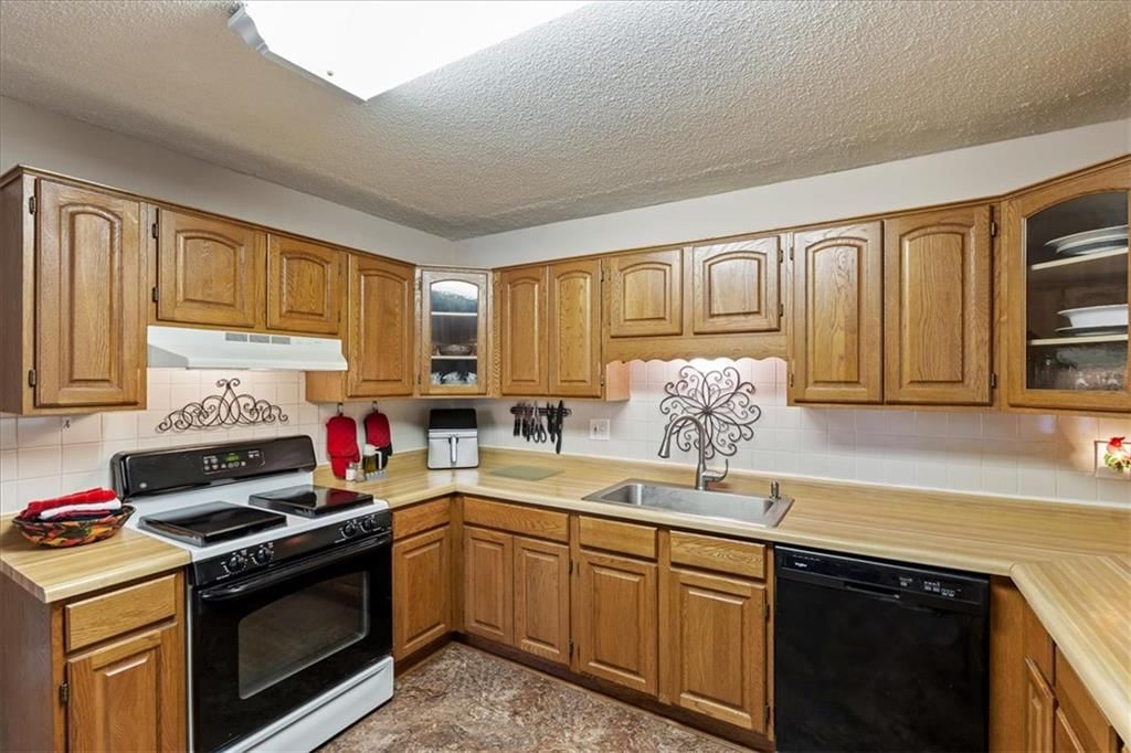 Butcher block countertops, wood kitchen cabinets and kitchen backsplash at 503 NE 67th Terrace, Gladstone, MO 64118