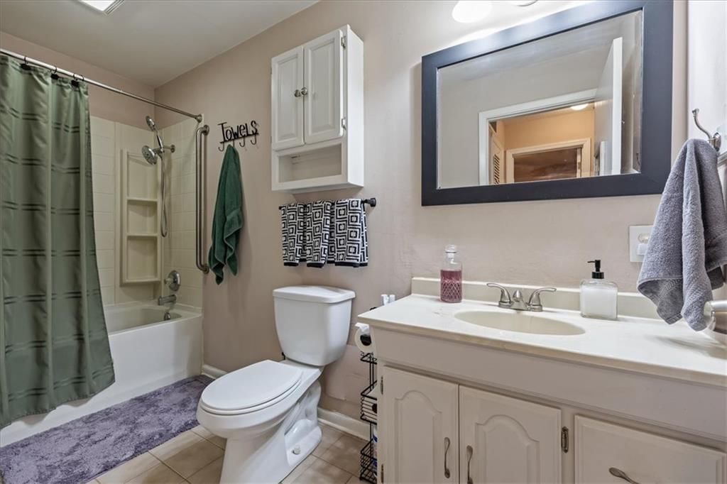 Tiled shower, double vanity and greige vanity color at 503 NE 67th Terrace, Gladstone, MO 64118