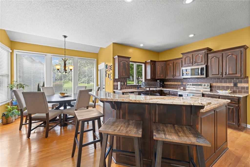 Electric range, subway tile backsplash and beige or brown countertops at 22007 52nd Street, Shawnee, KS 66226